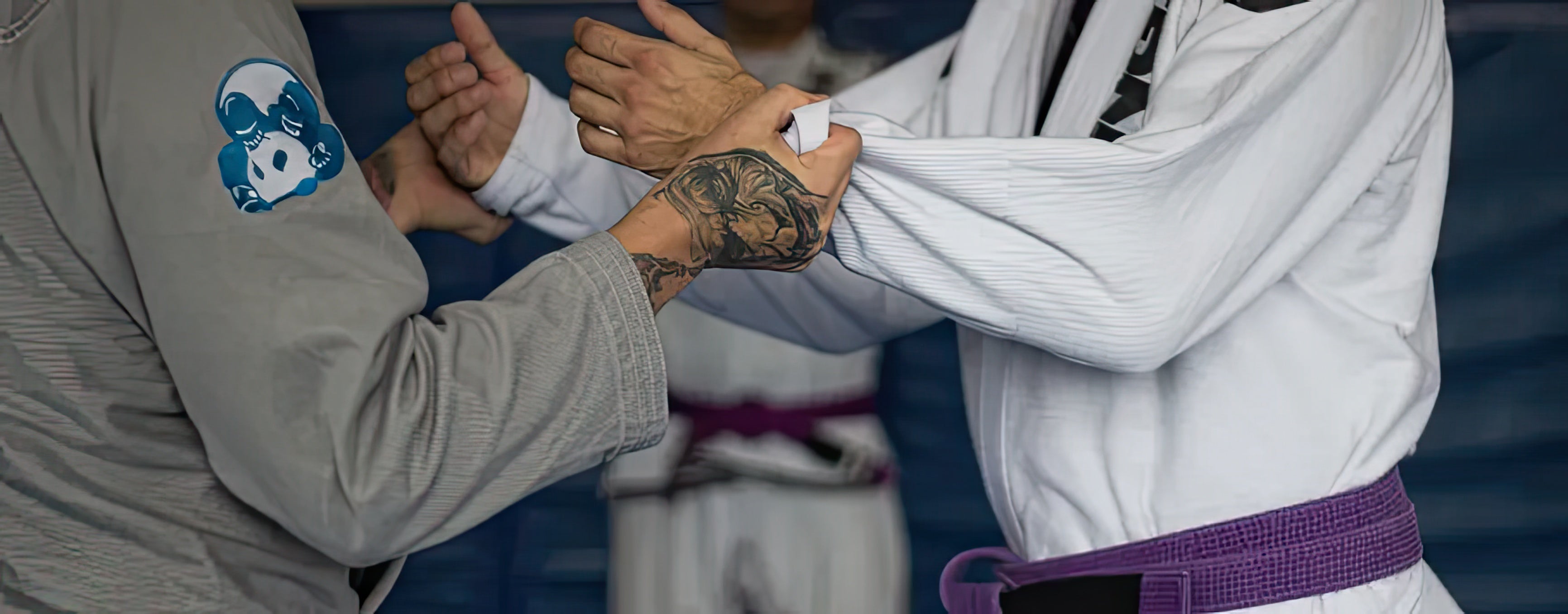 Close-up of a Brazilian Jiu-Jitsu gi grip technique during practice